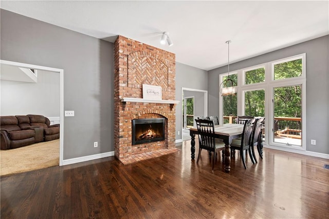 414 N 4th St, Gower, MO 64454 - dining room with healthy amount of natural light, wood finished floors, and a fireplace