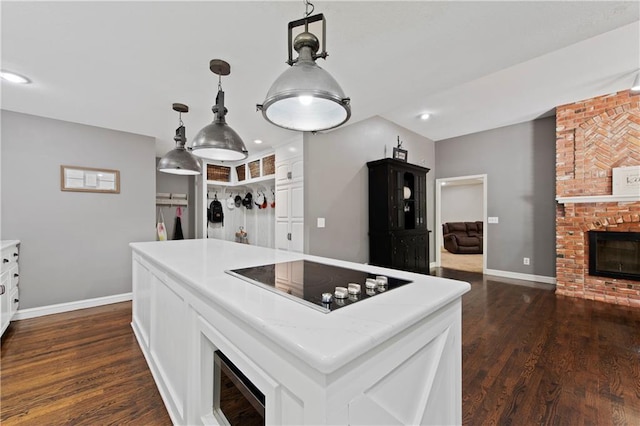 414 N 4th St, Gower, MO 64454 - kitchen with black electric cooktop, white cabinetry, light countertops, dark wood-style flooring, and recessed lighting