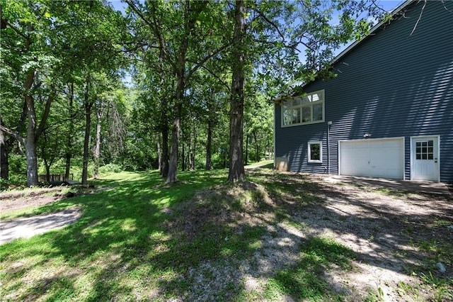 414 N 4th St, Gower, MO 64454 - view of grassy yard featuring a garage and driveway