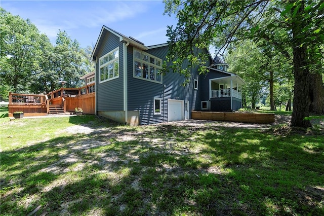 414 N 4th St, Gower, MO 64454 - back of house with an attached garage, a wooden deck, and a yard