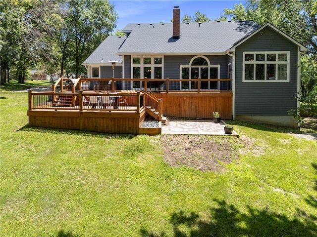 414 N 4th St, Gower, MO 64454 - rear view of house featuring a chimney, a patio, a lawn, a wooden deck, and a shingled roof