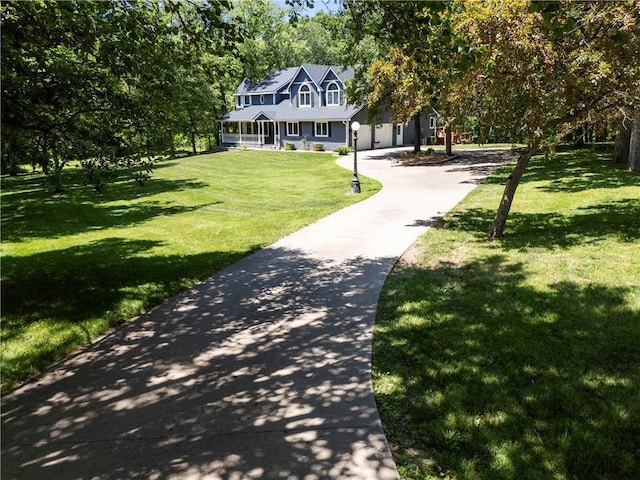 414 N 4th St, Gower, MO 64454 - view of front of home with a front lawn, driveway, and a porch