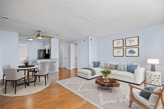 4143 Roanoke Rd Unit 10, Kansas City, MO 64111 - living area featuring light wood-style floors and ceiling fan
