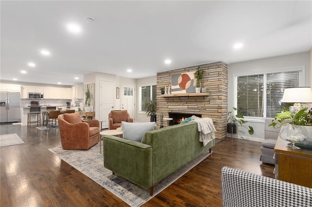 1304 Nashua Rd, Liberty, MO 64068 - living room with dark wood finished floors, a stone fireplace, and recessed lighting