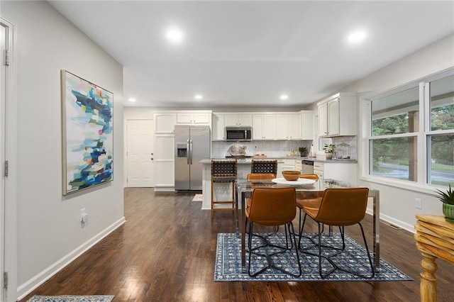 1304 Nashua Rd, Liberty, MO 64068 - kitchen with appliances with stainless steel finishes, white cabinets, a kitchen island, dark wood-style floors, and recessed lighting