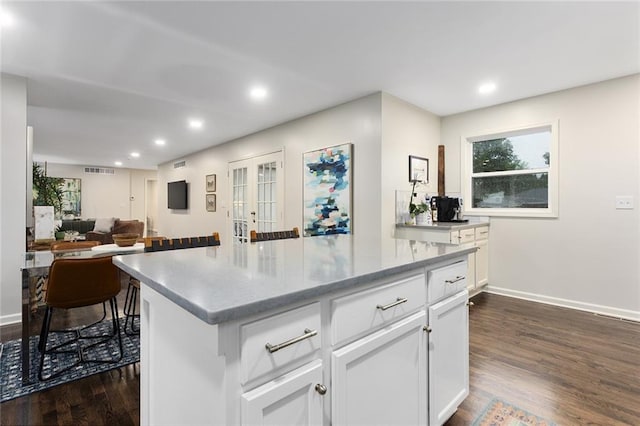 1304 Nashua Rd, Liberty, MO 64068 - kitchen with dark wood-style floors, white cabinets, recessed lighting, a kitchen island, and open floor plan