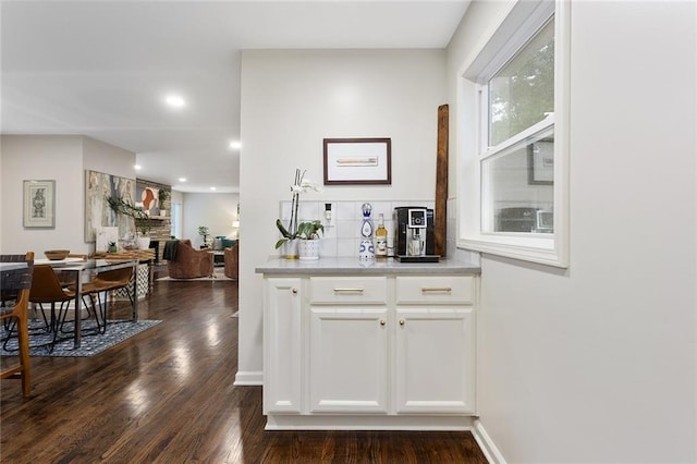 1304 Nashua Rd, Liberty, MO 64068 - bar area featuring dark wood finished floors, a stone fireplace, tasteful backsplash, and recessed lighting
