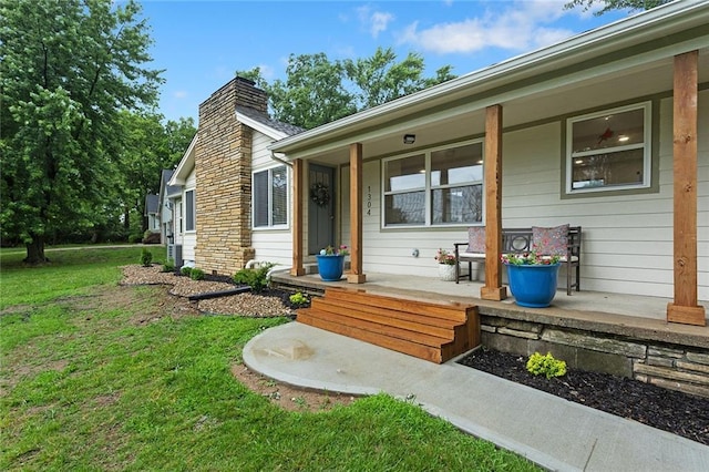 1304 Nashua Rd, Liberty, MO 64068 - doorway to property with a porch, a chimney, and a yard