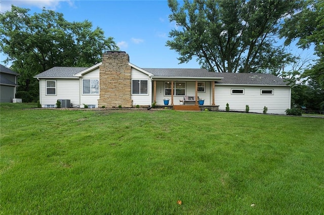 1304 Nashua Rd, Liberty, MO 64068 - back of property featuring covered porch, a yard, and a chimney