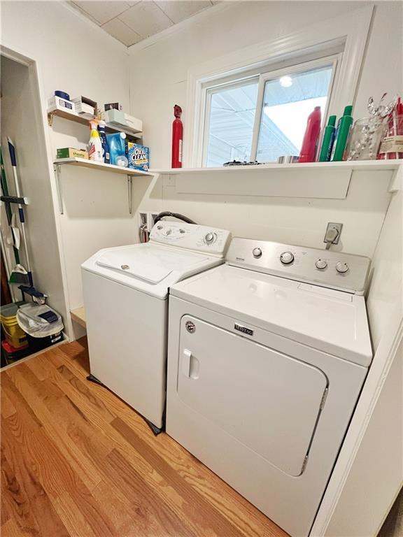 3342 Duncan St, Saint Joseph, MO 64507 - washroom with light wood-type flooring and washer and clothes dryer