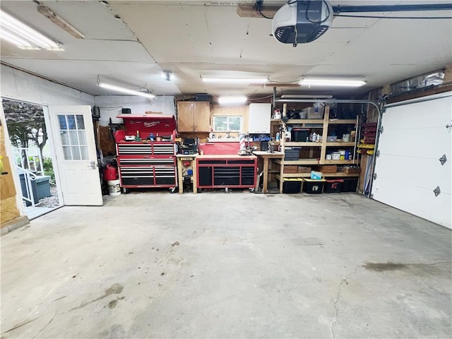 3342 Duncan St, Saint Joseph, MO 64507 - garage with a garage door opener and a workshop area