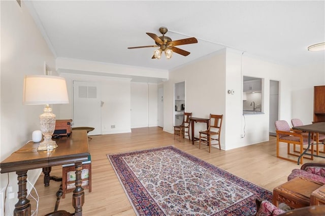 333 W Meyer Blvd # 212, Kansas City, MO 64113 - living area with ceiling fan, ornamental molding, and wood finished floors