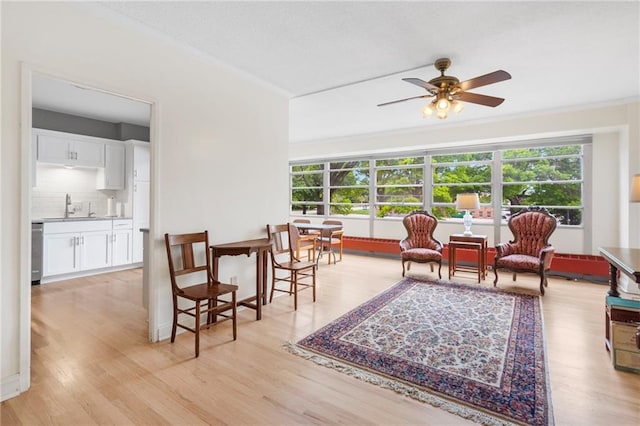333 W Meyer Blvd # 212, Kansas City, MO 64113 - sitting room with healthy amount of natural light, ceiling fan, light wood-style floors, and ornamental molding