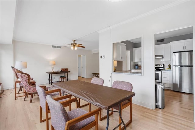 333 W Meyer Blvd # 212, Kansas City, MO 64113 - dining space featuring light wood finished floors, crown molding, and ceiling fan