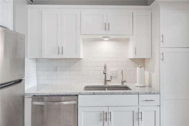 333 W Meyer Blvd # 212, Kansas City, MO 64113 - kitchen featuring stainless steel appliances, white cabinets, backsplash, and light stone countertops