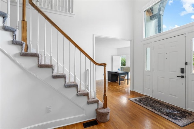 14712 Woodward St, Overland Park, KS 66223 - entrance foyer featuring wood finished floors, stairs, and a high ceiling