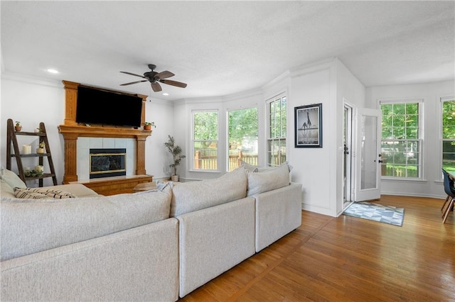 14712 Woodward St, Overland Park, KS 66223 - living area featuring ceiling fan, wood finished floors, a fireplace, crown molding, and recessed lighting