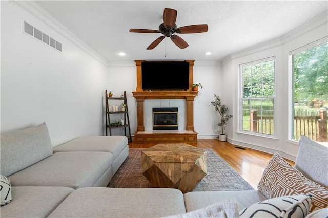 14712 Woodward St, Overland Park, KS 66223 - living area with light wood-type flooring, ornamental molding, a ceiling fan, recessed lighting, and a fireplace