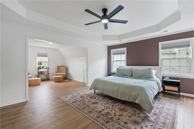 14712 Woodward St, Overland Park, KS 66223 - bedroom with a tray ceiling, crown molding, wood finished floors, and ceiling fan