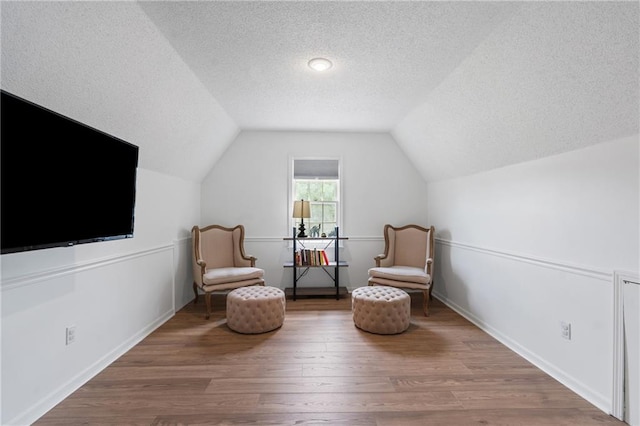 14712 Woodward St, Overland Park, KS 66223 - living area with a textured ceiling, wood finished floors, and vaulted ceiling