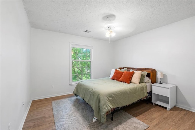 14712 Woodward St, Overland Park, KS 66223 - bedroom featuring light wood-style floors and a textured ceiling