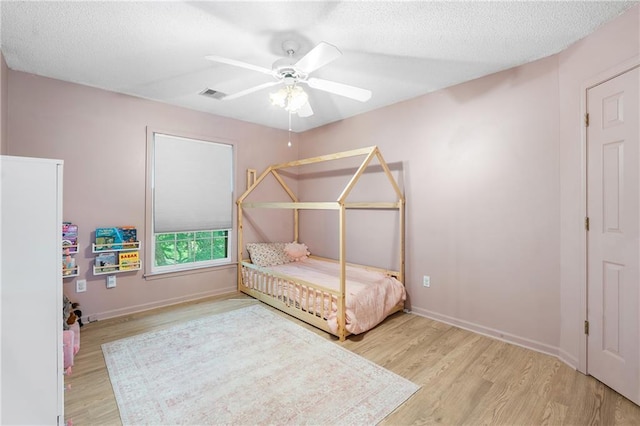 14712 Woodward St, Overland Park, KS 66223 - bedroom with wood finished floors, a textured ceiling, and ceiling fan