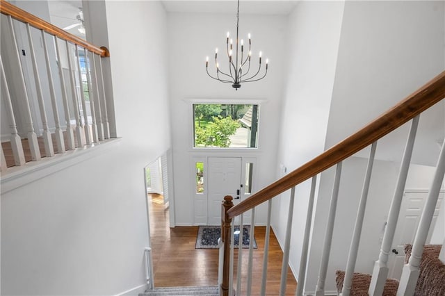 14712 Woodward St, Overland Park, KS 66223 - entrance foyer featuring a high ceiling, stairway, wood finished floors, a chandelier, and ceiling fan