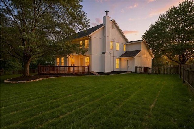 14712 Woodward St, Overland Park, KS 66223 - back of property with a fenced backyard, a deck, and a chimney