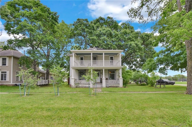 118 7th St, Baldwin City, KS 66006 - view of front of home featuring a porch, a front lawn, and a balcony