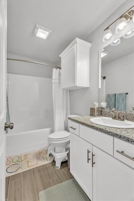 21404 W 47th Ter, Shawnee, KS 66218 - full bathroom with shower / tub combo with curtain, vanity, and wood finished floors