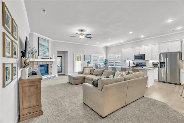 21404 W 47th Ter, Shawnee, KS 66218 - living room with ornamental molding, recessed lighting, a glass covered fireplace, ceiling fan, and light wood-type flooring