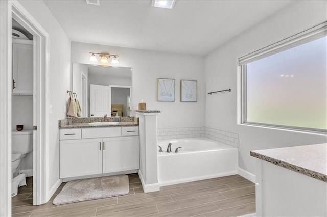 21404 W 47th Ter, Shawnee, KS 66218 - bathroom featuring wood finish floors, vanity, and a bath