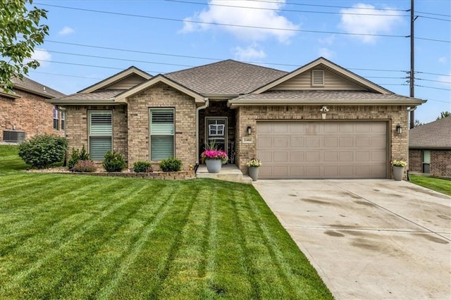 21404 W 47th Ter, Shawnee, KS 66218 - view of front facade with a front yard, brick siding, concrete driveway, and an attached garage