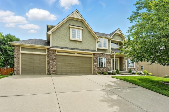 2312 NE Sweet Water Dr, Lees Summit, MO 64086 - view of front of house featuring driveway, stucco siding, an attached garage, and brick siding