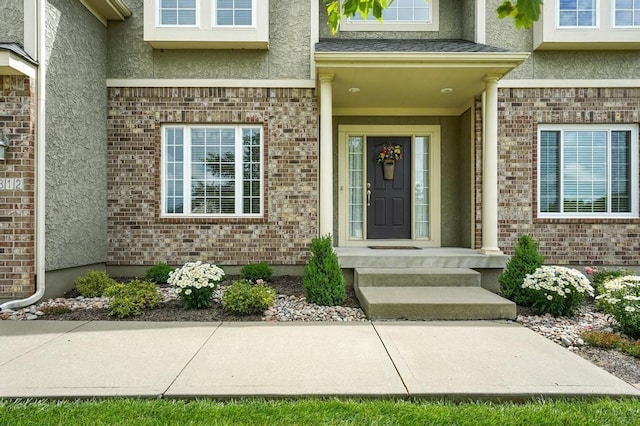 2312 NE Sweet Water Dr, Lees Summit, MO 64086 - doorway to property with stucco siding and brick siding