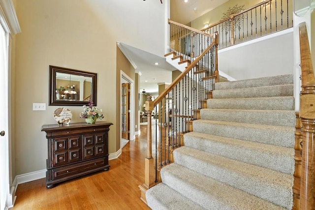 2312 NE Sweet Water Dr, Lees Summit, MO 64086 - staircase featuring a towering ceiling, wood finished floors, and recessed lighting