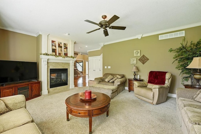 2312 NE Sweet Water Dr, Lees Summit, MO 64086 - living room with crown molding, carpet flooring, ceiling fan, and a tiled fireplace