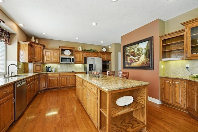 2312 NE Sweet Water Dr, Lees Summit, MO 64086 - kitchen with open shelves, appliances with stainless steel finishes, light wood-style flooring, backsplash, and recessed lighting