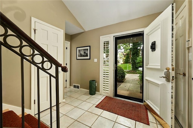 490 W 49th Ter, Kansas City, MO 64112 - entrance foyer featuring vaulted ceiling, light tile patterned flooring, and stairs