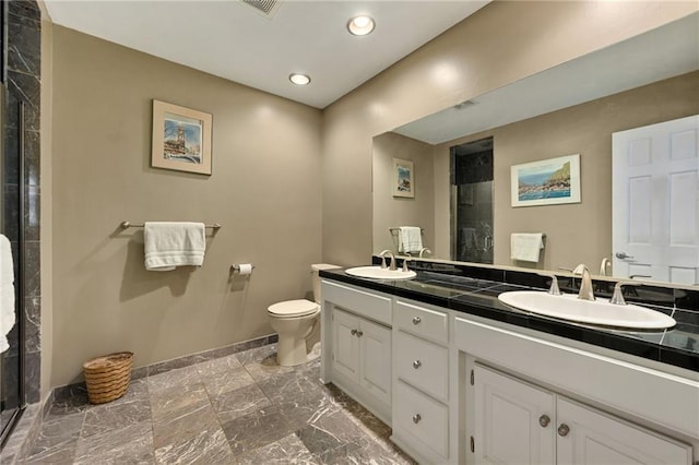 490 W 49th Ter, Kansas City, MO 64112 - bathroom with double vanity, marble finish flooring, tiled shower, and recessed lighting