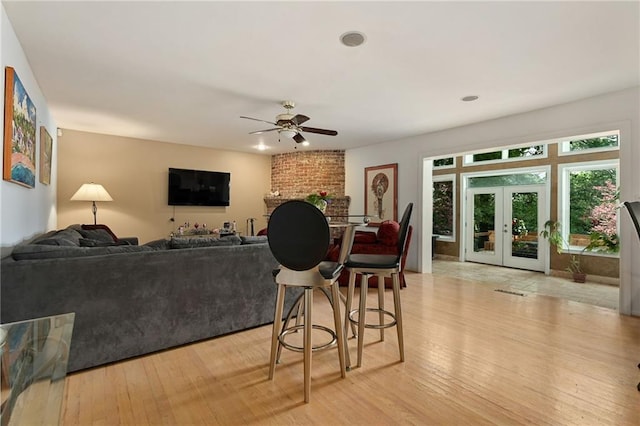 490 W 49th Ter, Kansas City, MO 64112 - living room with ceiling fan, light wood-style flooring, and french doors