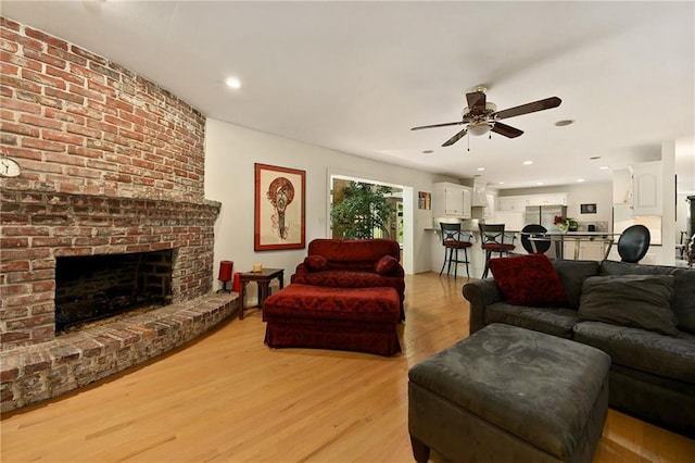 490 W 49th Ter, Kansas City, MO 64112 - living area with a ceiling fan, light wood-type flooring, a brick fireplace, and recessed lighting
