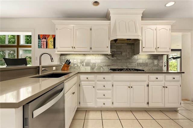 490 W 49th Ter, Kansas City, MO 64112 - kitchen featuring appliances with stainless steel finishes, light tile patterned floors, plenty of natural light, a peninsula, and recessed lighting