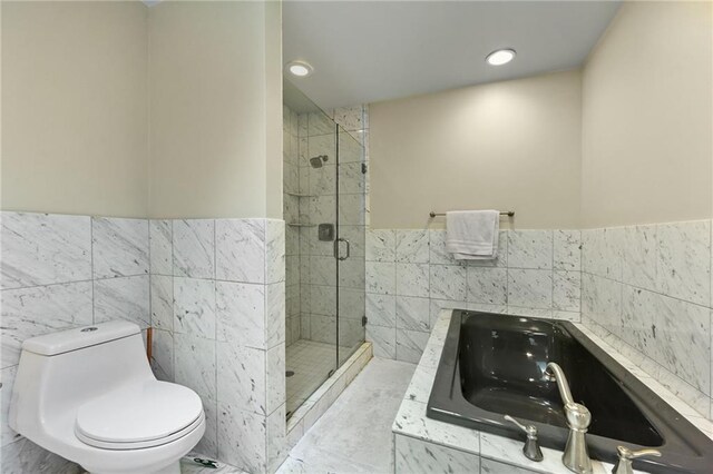 490 W 49th Ter, Kansas City, MO 64112 - bathroom with tile walls, a bath, a shower stall, wainscoting, and recessed lighting