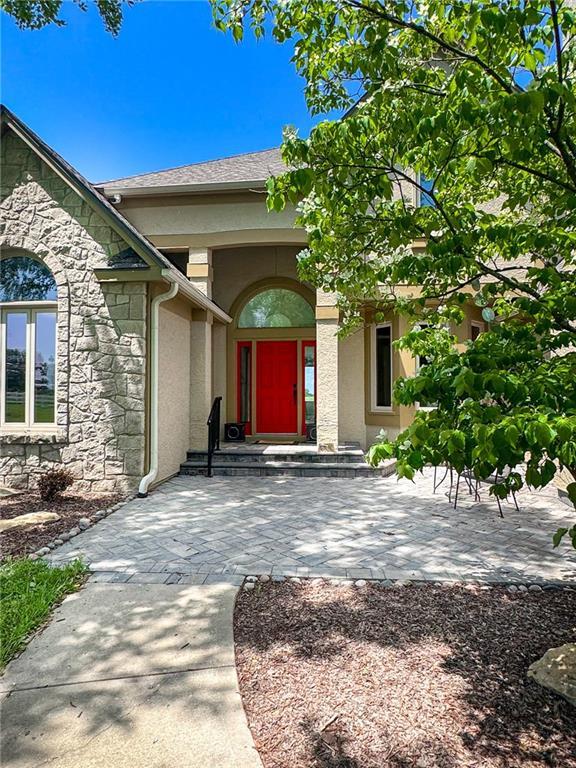 26528-23.09 S Metcalf Rd, Louisburg, KS 66053 - entrance to property featuring stone siding and stucco siding