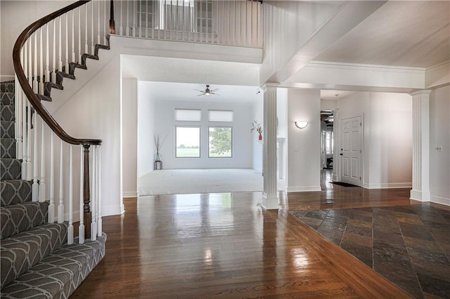 26528-23.09 S Metcalf Rd, Louisburg, KS 66053 - entryway with ornate columns, stairway, crown molding, and wood finished floors