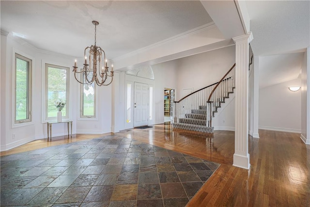 26528-23.09 S Metcalf Rd, Louisburg, KS 66053 - foyer featuring stairs, ornate columns, a chandelier, stone tile floors, and crown molding