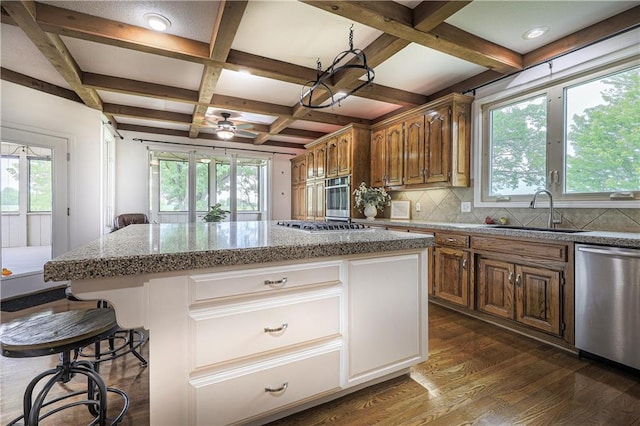 26528-23.09 S Metcalf Rd, Louisburg, KS 66053 - kitchen with stainless steel appliances, dark wood-type flooring, a kitchen island, coffered ceiling, and tasteful backsplash
