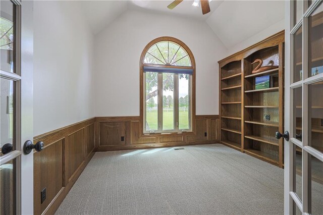 26528-23.09 S Metcalf Rd, Louisburg, KS 66053 - unfurnished room featuring a wainscoted wall, carpet floors, ceiling fan, french doors, and lofted ceiling