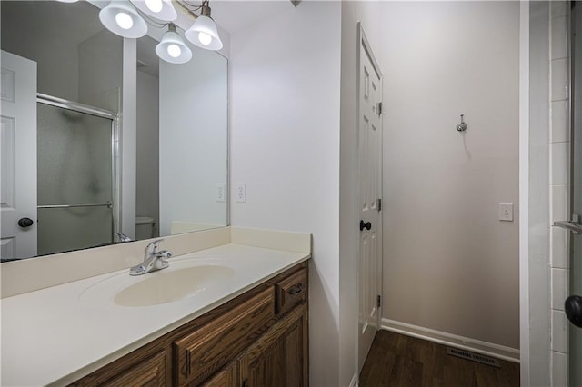 26528-23.09 S Metcalf Rd, Louisburg, KS 66053 - bathroom with vanity, wood finished floors, and an enclosed shower